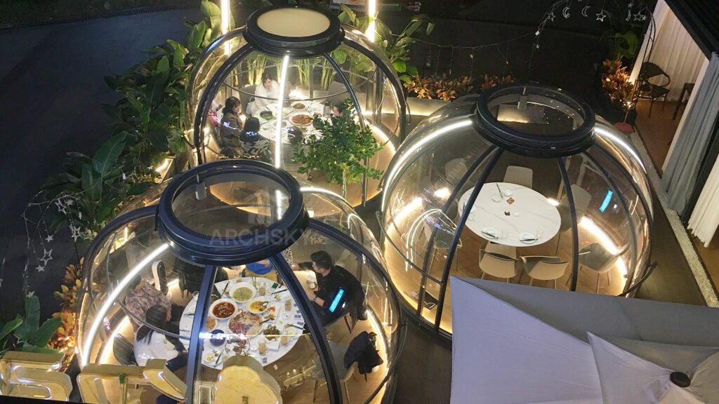 Outdoor Dining in Clear Dome Sunrooms at Night